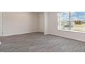 Bright living room featuring gray vinyl flooring and large windows at 322 Acosta Circle, Conway, SC 29527