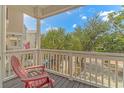 Relaxing front porch with a red Adirondack chair and view of the street at 2406 Pointe Marsh Ln., North Myrtle Beach, SC 29582