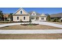 Tan house with gray roof, landscaping, and a long driveway at 1100 Maccoa Dr., Conway, SC 29526