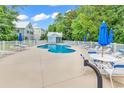 Community pool with plenty of lounge chairs and umbrellas at 6 Cottage Dr., Murrells Inlet, SC 29576