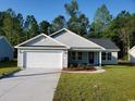 Newly constructed light gray house with a white garage door at Tbd 4 Casey Dr., Nichols, SC 29581
