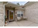 Brick front porch with seating area and decorative planters at 355 Foxtail Dr., Longs, SC 29568