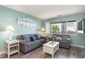 Beachy living room with gray sofas, white coffee table, and ocean-themed art at 202 75Th Ave N # 5706/5707, Myrtle Beach, SC 29572