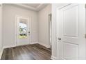 Home entryway with wood-look flooring and white door at 407 Glacier Way, Conway, SC 29526