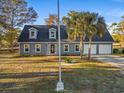 Newly renovated gray house with a two-car garage and well-manicured lawn at 1350 Crooked Pine Dr., Surfside Beach, SC 29575