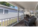 Covered back porch with seating area and ceiling fan at 6001 - 1824 S Kings Hwy., Myrtle Beach, SC 29575