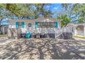 Quaint beach cottage showcasing white exterior, teal accents, and a welcoming front porch at 6001- L40 S Kings Hwy., Myrtle Beach, SC 29575