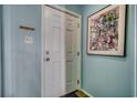 Light blue walls and white door in the entryway at 116 South Waccamaw Dr. # 204, Garden City Beach, SC 29576