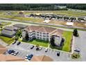 Apartment building with surrounding parking and nearby construction at 124 South Shore Blvd. # 303, Longs, SC 29568