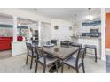 Bright dining room features a large table with seating for six and views into the living room and kitchen at 127 Garden City Connector # 210, Murrells Inlet, SC 29576