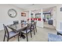 Open concept dining room with a large table, seating for six, and views of the living room at 127 Garden City Connector # 210, Murrells Inlet, SC 29576
