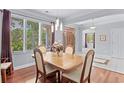 Dining area with hardwood floors, light walls, and wood table with seating for four at 3420 Cedar Creek Run, Little River, SC 29566