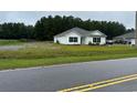 White house with teal door and a spacious yard at 1884 Mount Zion Rd., Loris, SC 29569