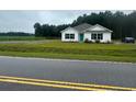 White house with teal door and a spacious yard at 1884 Mount Zion Rd., Loris, SC 29569