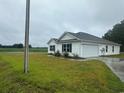 White house with attached garage and spacious backyard at 1884 Mount Zion Rd., Loris, SC 29569