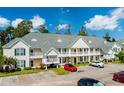 Two-story building exterior with ample parking and landscaping at 146 Scotch Broom Dr. # P-204, Little River, SC 29566