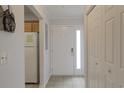 Bright entryway with tiled floors, white door, and coat closets at 146 Scotch Broom Dr. # P-204, Little River, SC 29566