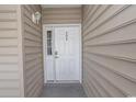 Inviting condo entry with a white door and sidelight at 5810 Longwood Dr. # 14-304, Murrells Inlet, SC 29576