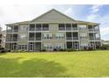 Condo building exterior showcasing multiple screened porches at 5810 Longwood Dr. # 14-304, Murrells Inlet, SC 29576