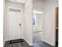 Bright entryway with door, hardwood floor, and view into room at 580 Duvall St., Longs, SC 29568