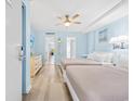 Bright bedroom with two beds, light blue walls, and wood-look floors at 210 75Th Ave. N # 4045, Myrtle Beach, SC 29572
