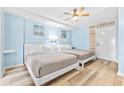 Bedroom with two beds, light blue walls, and wood-look floors at 210 75Th Ave. N # 4045, Myrtle Beach, SC 29572