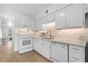 Bright kitchen with white cabinets, quartz counters, and stainless appliances at 1621 Edge Dr. # 4, North Myrtle Beach, SC 29582