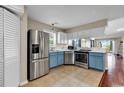 Modern kitchen with stainless steel appliances and blue cabinets at 4255 Villas Dr. # 201, Little River, SC 29566