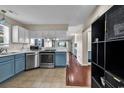 Modern kitchen with stainless steel appliances and blue cabinets at 4255 Villas Dr. # 201, Little River, SC 29566
