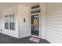 Front door entry with porch and seasonal decor at 5056 Glenbrook Dr. # 202, Myrtle Beach, SC 29579