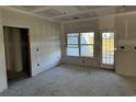 Bright living room featuring a door to backyard access at 4979 Dupont Rd., Aynor, SC 29511