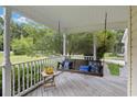 Relaxing front porch with a swing and a view of the backyard at 9396 S Highway 905, Longs, SC 29568