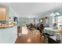 Open floor plan with hardwood floors, leather furniture and dining area at 5882 Longwood Dr. # 204, Murrells Inlet, SC 29576