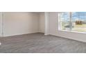Spacious living room with gray vinyl plank flooring and large windows at 831 Buttonwood Dr., Conway, SC 29527