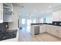 Modern kitchen with white cabinets, stainless steel appliances, and herringbone backsplash at Tbb1 Shady Grove Rd., Conway, SC 29527