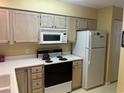 Kitchen with white appliances, light wood cabinets, and ample counter space at 660 Tupelo Ln. # 7I, Longs, SC 29568