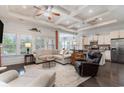 Spacious living room with hardwood floors and coffered ceiling at 794 Thistle Trail, Calabash, NC 28467