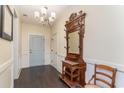 Elegant entryway with hardwood floors and antique hall tree at 794 Thistle Trail, Calabash, NC 28467