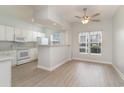 Kitchen with white cabinets, appliances, and a breakfast bar at 500 Willow Greens Dr. # B, Conway, SC 29526