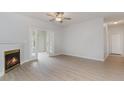Living room with fireplace, French doors, and wood-look flooring at 500 Willow Greens Dr. # B, Conway, SC 29526