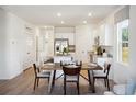 Open concept dining area with kitchen, wooden table, and chairs at 137 Talladega Dr. # 451, Myrtle Beach, SC 29579