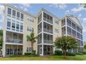 Three-story condo building with screened balconies and lush landscaping at 601 Hillside Dr. N # 3906, North Myrtle Beach, SC 29582