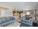 Living room with blue striped couches and view of kitchen at 5905 S Kings Highway # 219-B, Myrtle Beach, SC 29575