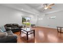Spacious living room with hardwood floors, leather sofa, and glass coffee table at 141 Terracina Circle, Myrtle Beach, SC 29588