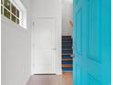 Bright entryway with teal door, stairs, and interior door at 141 Terracina Circle, Myrtle Beach, SC 29588