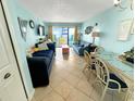 Bright living room with ocean view, sofa, and dining area at 2000 Ocean Blvd. S # 306, Myrtle Beach, SC 29577