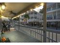 Relaxing front porch with ceiling fan, string lights, and neighborhood view at 6001-5027 S Kings Hwy., Myrtle Beach, SC 29575