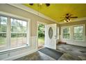 Sunroom with yellow ceiling, tile floor and access to backyard at 8543 Highway 814, Myrtle Beach, SC 29588