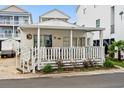 White cottage with a porch, surrounded by other houses at 6001-1092 S Kings Hwy., Myrtle Beach, SC 29575