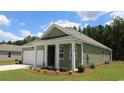 Two-story house with a covered porch and attached garage at 331 Cheerful Way, Little River, SC 29566